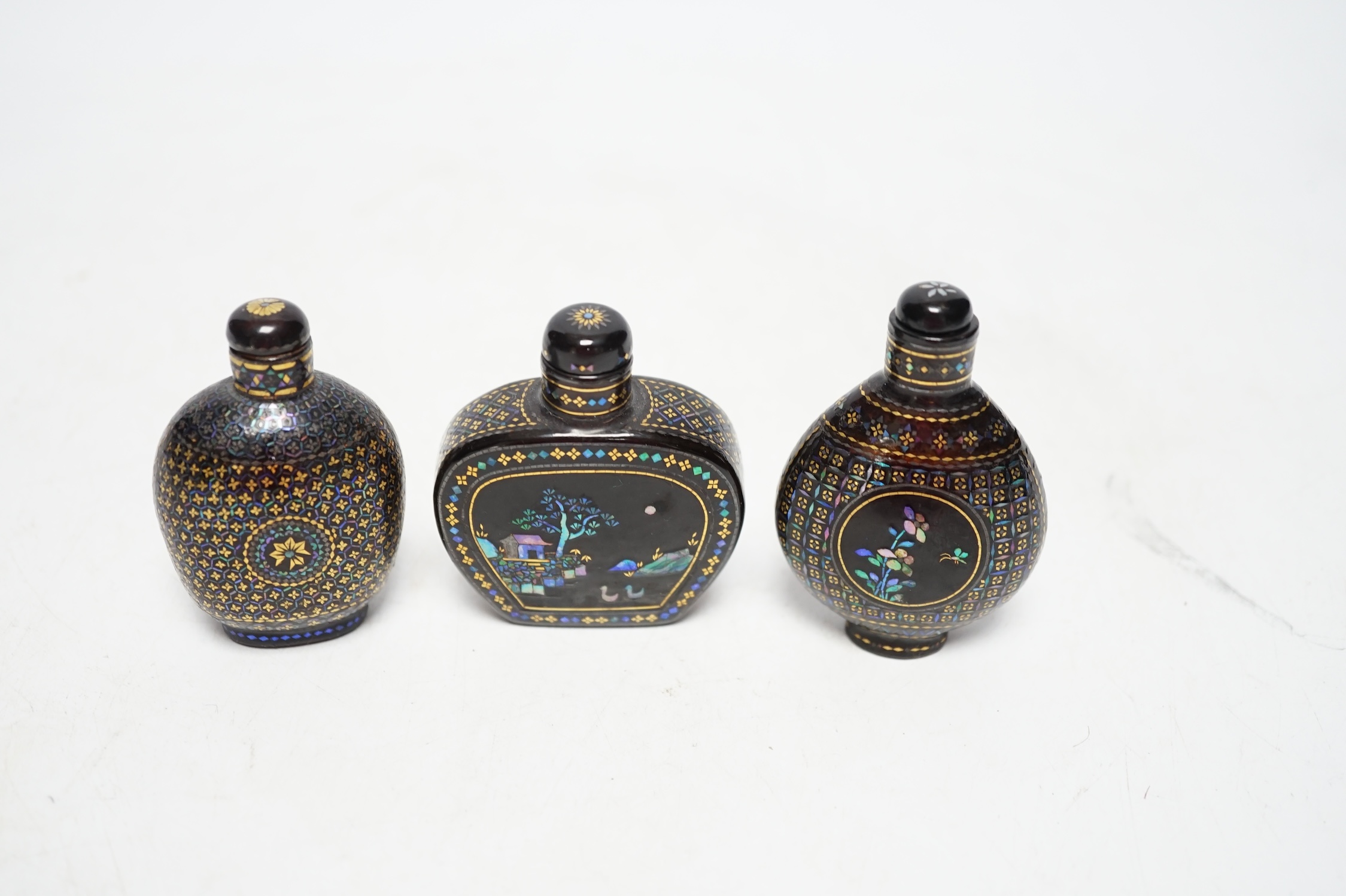 Three Chinese lac burgaute snuff bottles, 19th/20th century, largest 6cm high